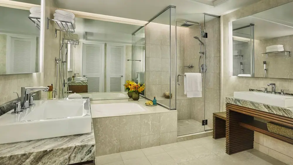 Four Seasons Resort Oahu guestroom bathroom with tiled shower walls and floor; reference photograph