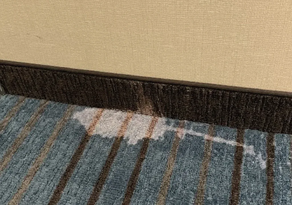 Before and after comparison of a permanent carpet dye repair for a bleach stain in a Honolulu hotel