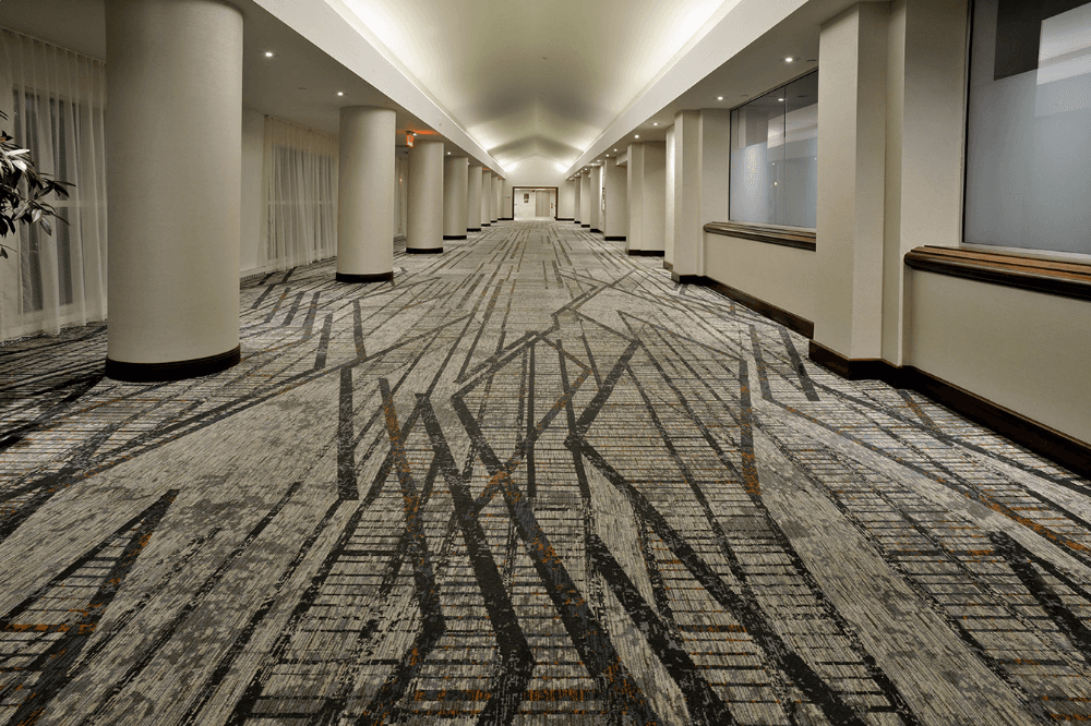 Professional restorative carpet cleaning for a high-traffic hotel hallway on Oahu by Renue Hawaii technicians.